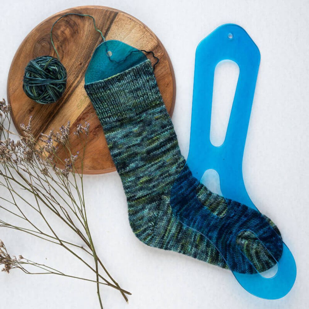 Hand-knitted sock displayed on a KnitPro Aqua Sock Blocker