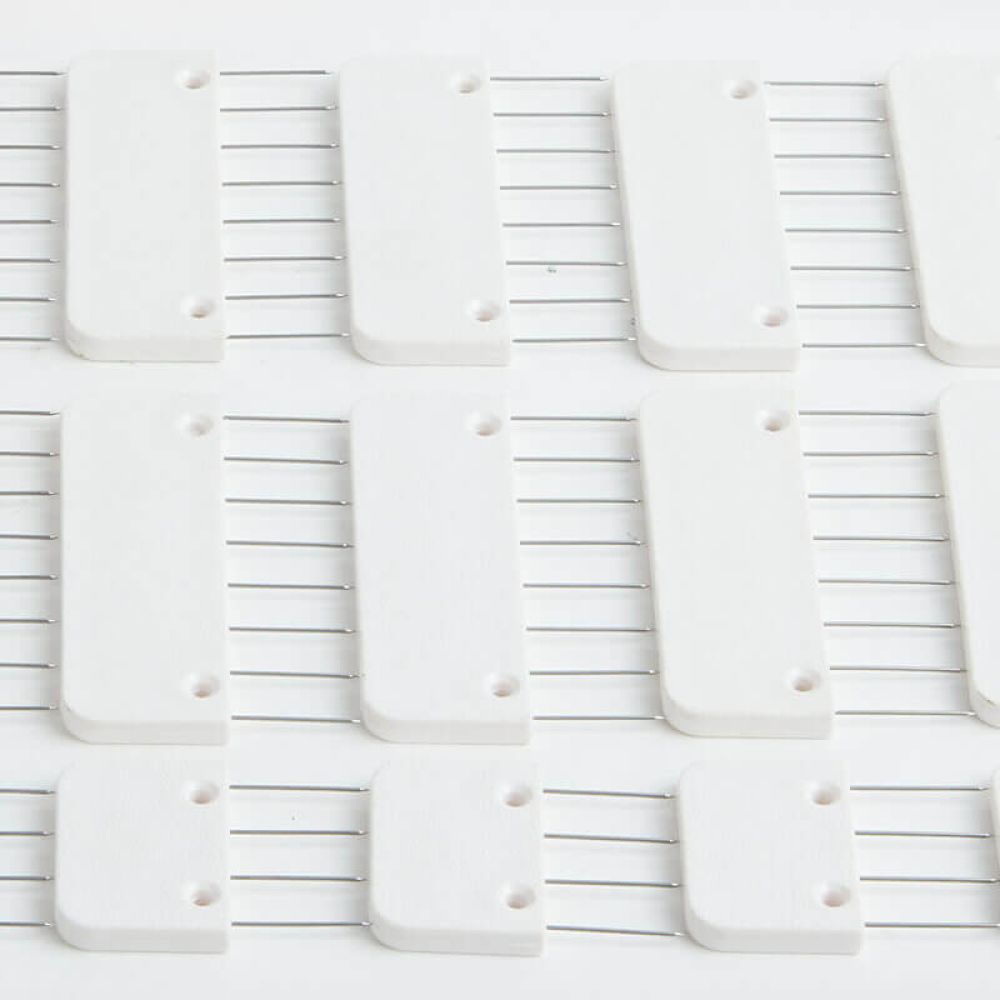Close view of KnitPro Knit Blocker steel pin spacing and string anchor holes