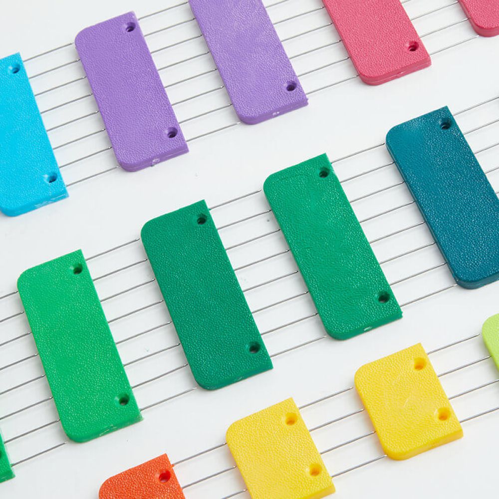 Close view of Rainbow Knit Blocker stainless-steel points and string anchor holes
