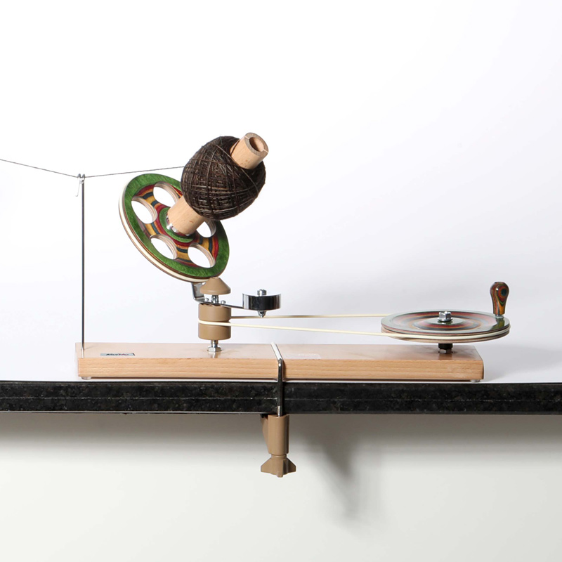 KnitPro Signature Mega Ball Winder forming a large brown centre-pull yarn cake